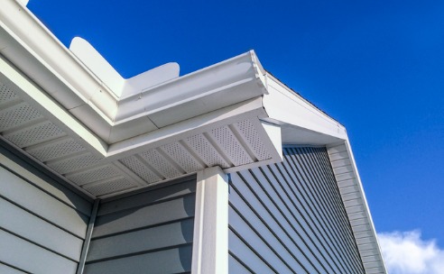 roofer-builder-worker-finishing-folding-a-metal-gutter-