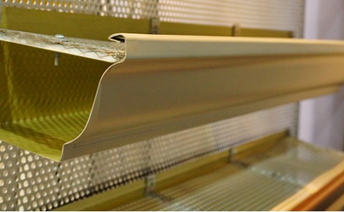 rain-gutter-system-on-roof-of-house-picture-id871263044