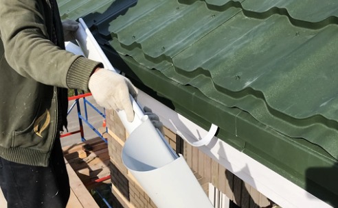 A contractor performing Gutter Repair in Bloomington IL