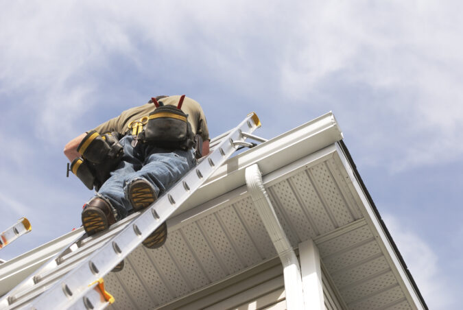 A member of Peoria Gutter Masters performs gutter repair on a home
