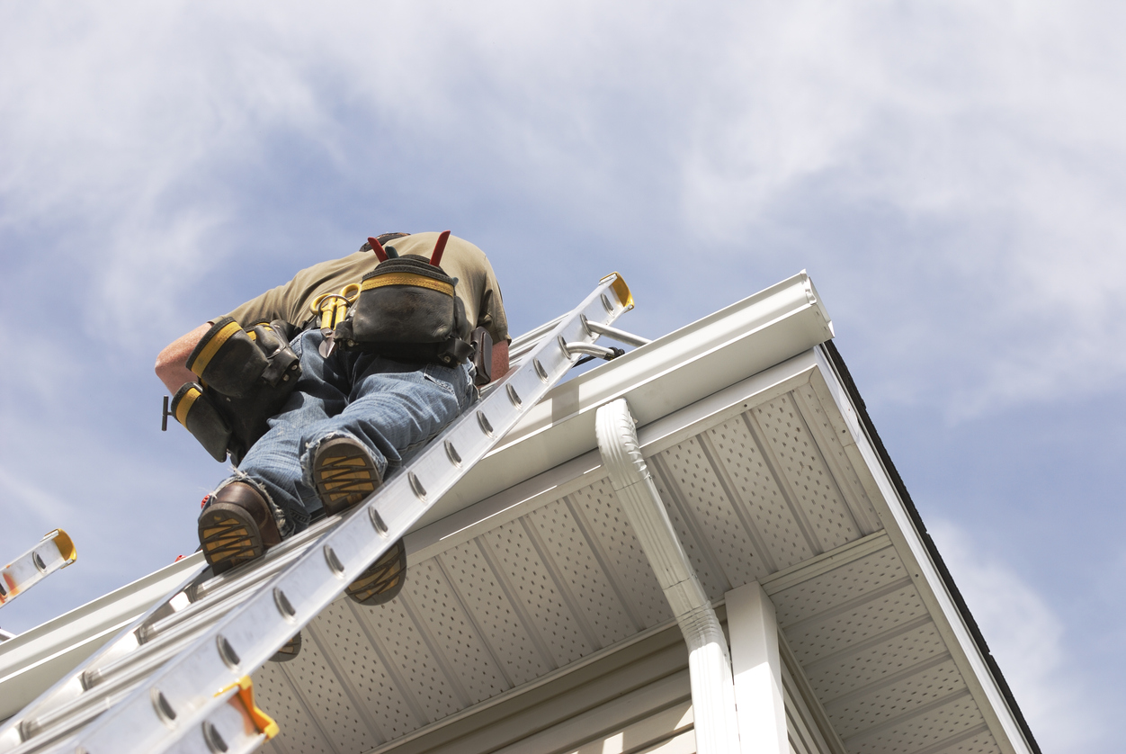 A member of Peoria Gutter Masters performs gutter repair on a home